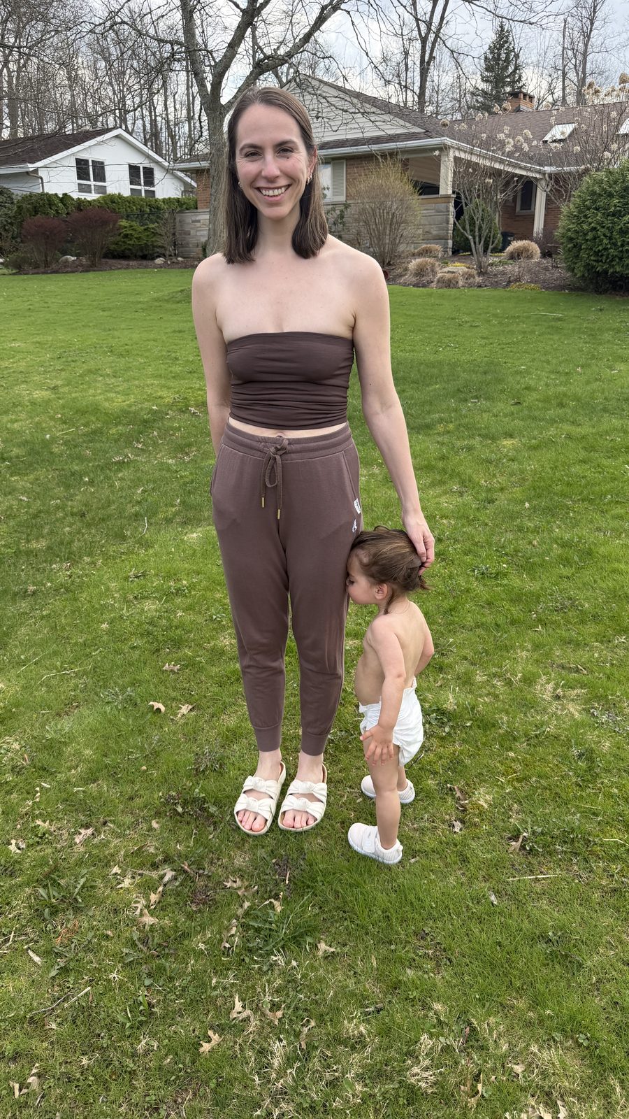 Mila nuzzling Lauren's leg in the yard