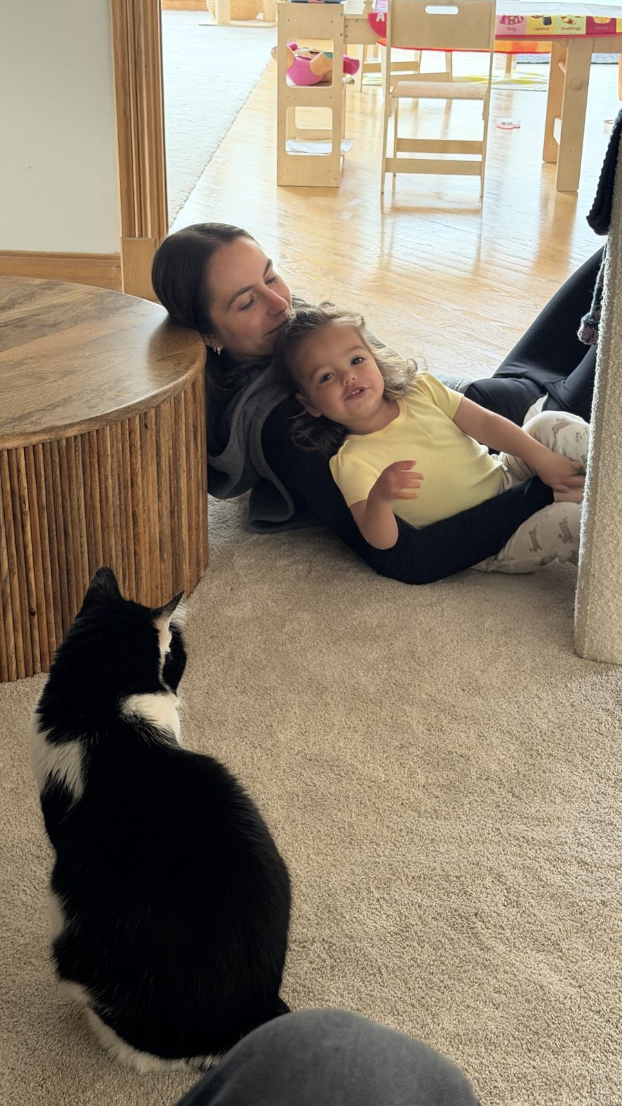 Lauren and Mila on the floor with the cat watching
