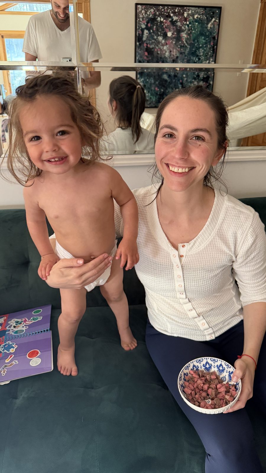 Lauren and Mila with a snack bowl, Dad in the mirror